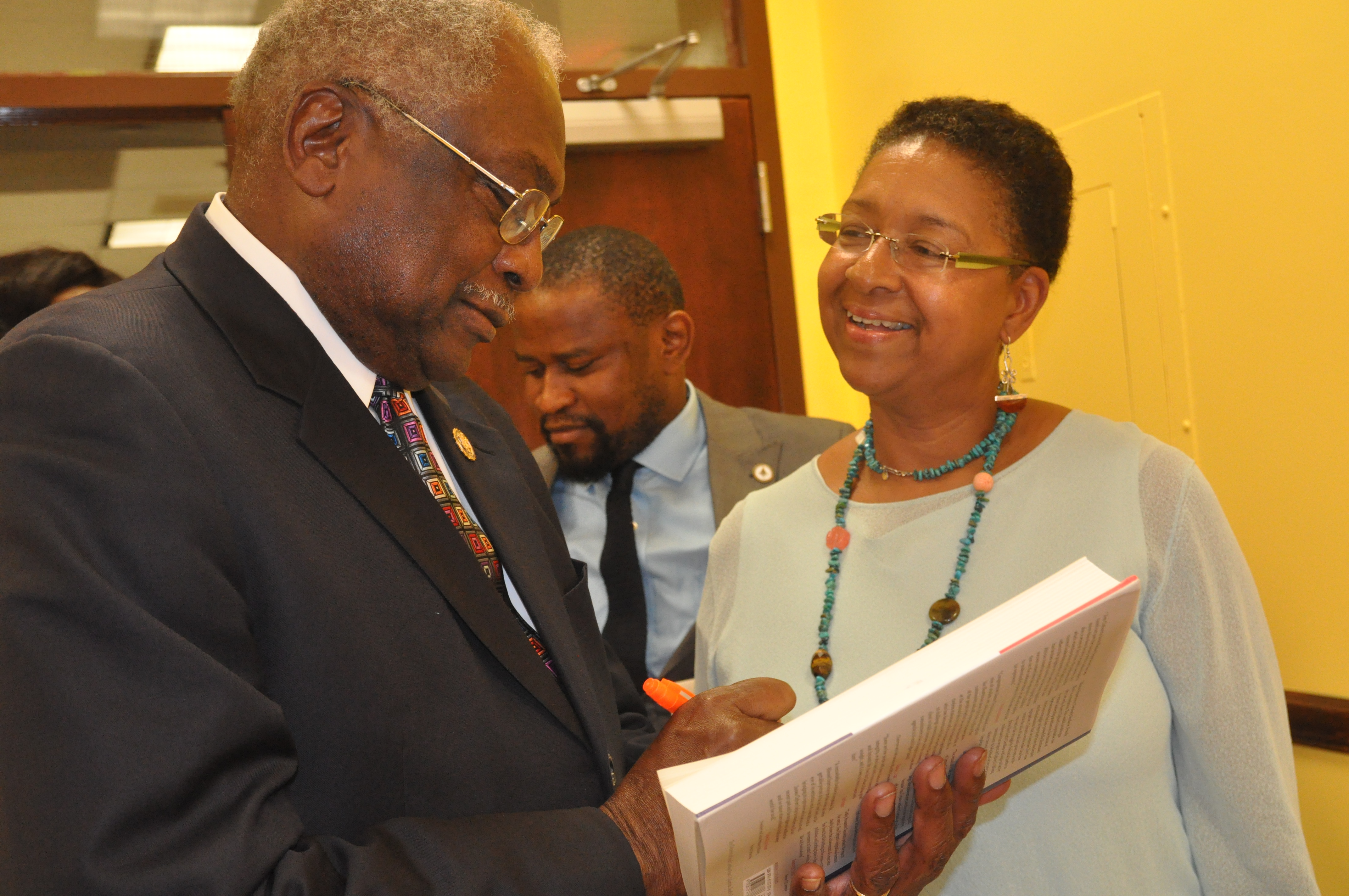 U.S. Representative James Clyburn of South Carolina signs books at Roxbury Community College.