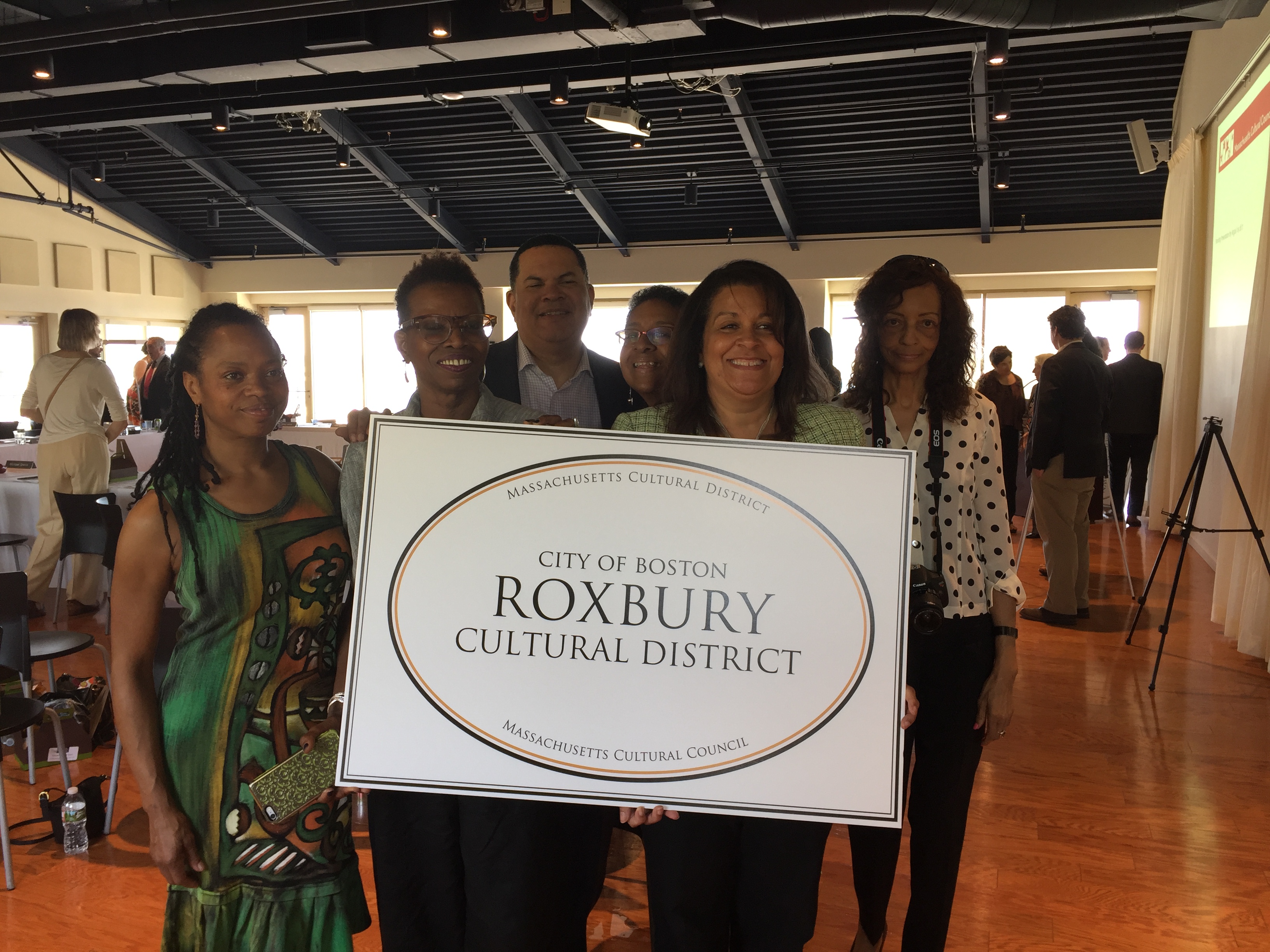 Celebrating the official designation of the Roxbury Cultural District by the Massachusetts Cultural Council are (left to right) Kristen Belton Willis a Roxbury artist, Carole Walton of the American City Coalition, Brooke Woodson of the Madison Park Development Corporation (MPDC), Kelley Chunn, Jeanne Pinado of the MPDC and Carrie Guscott of Davis Education in Roxbury.